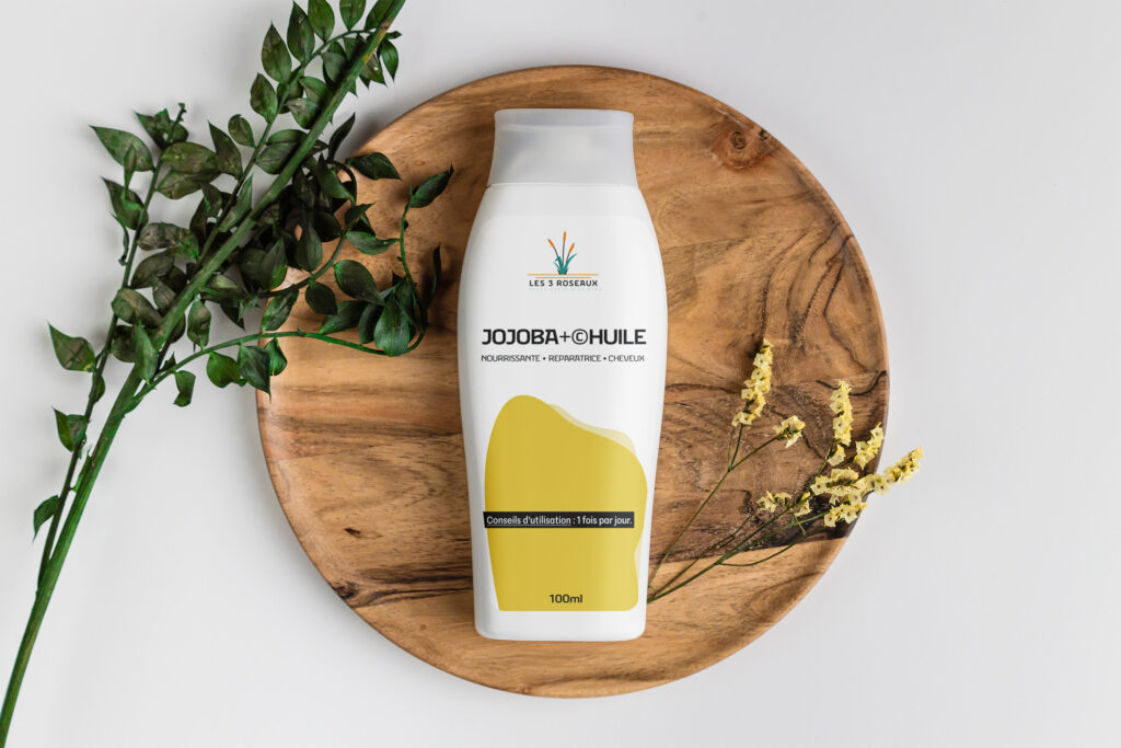 Bouteille d'huile de jojoba blanche avec une étiquette jaune